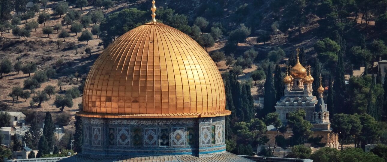 Golden Dome of the Rock with the Church of Mary Magdalene visible on the Mount of Olives in Jerusalem.